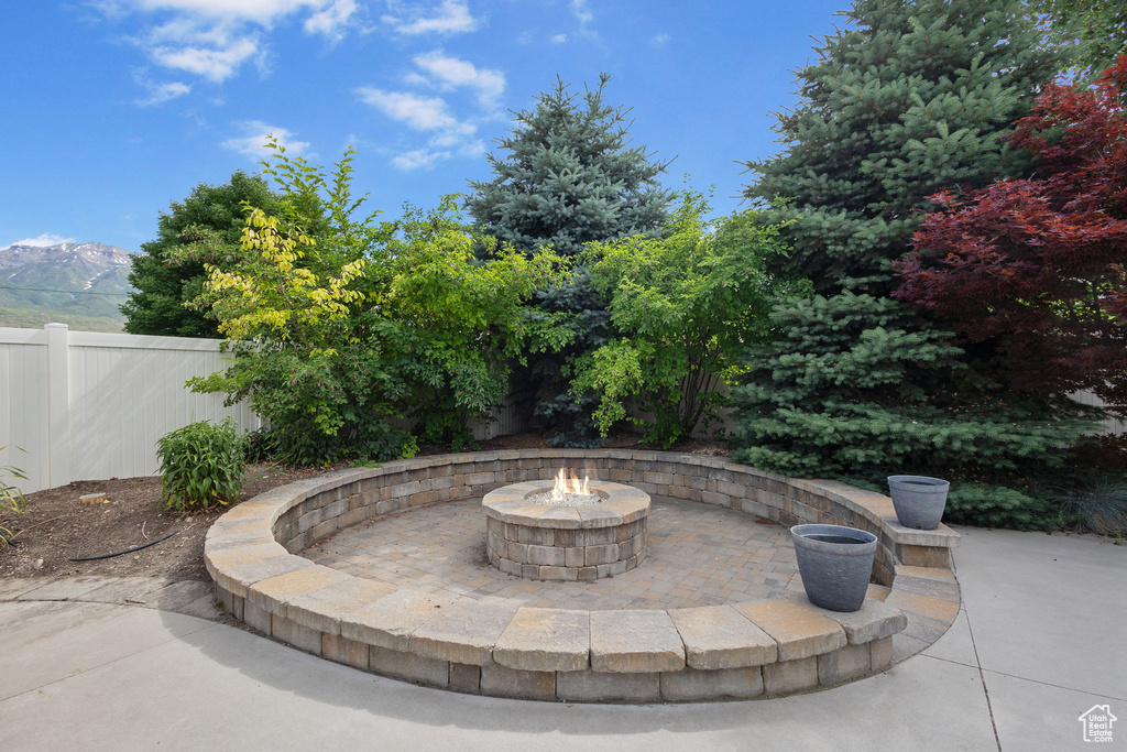View of patio / terrace featuring an outdoor fire pit and a mountain view