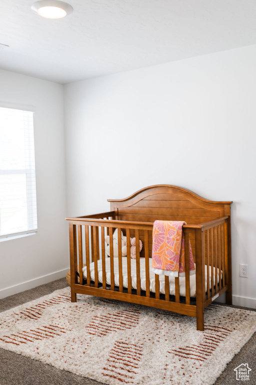Carpeted bedroom featuring baseboards