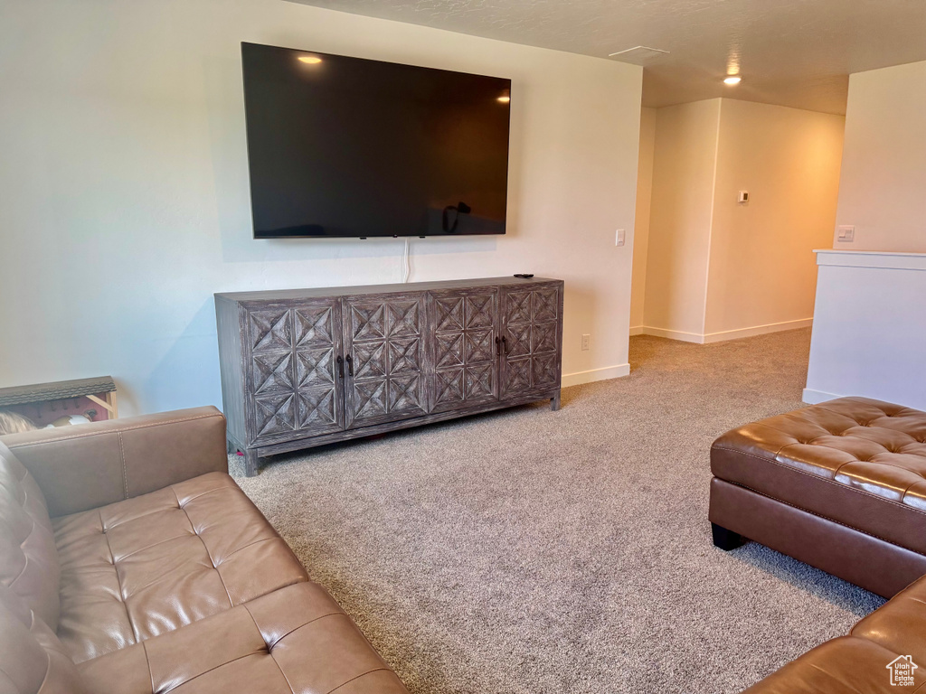 Living area with carpet flooring and baseboards