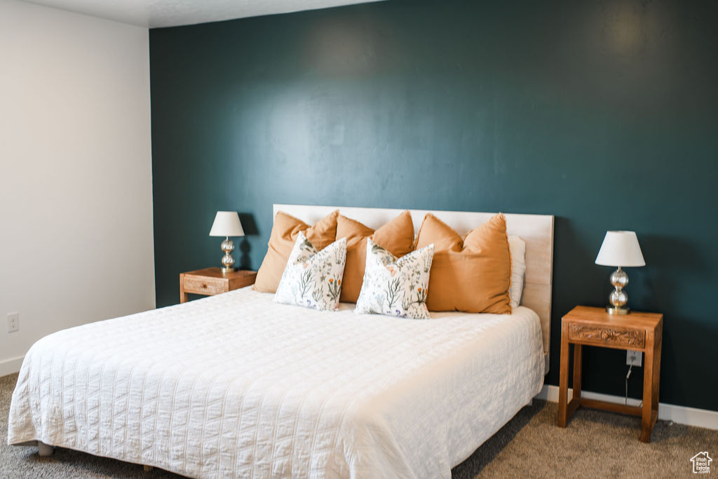 Carpeted bedroom featuring baseboards