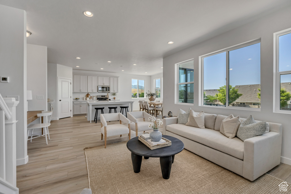 Living room featuring recessed lighting and light wood-type flooring
