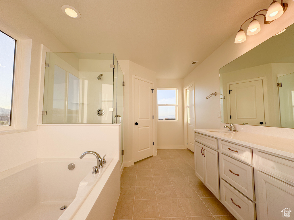 Bathroom featuring a stall shower, vanity, a bath, tile patterned flooring, and recessed lighting