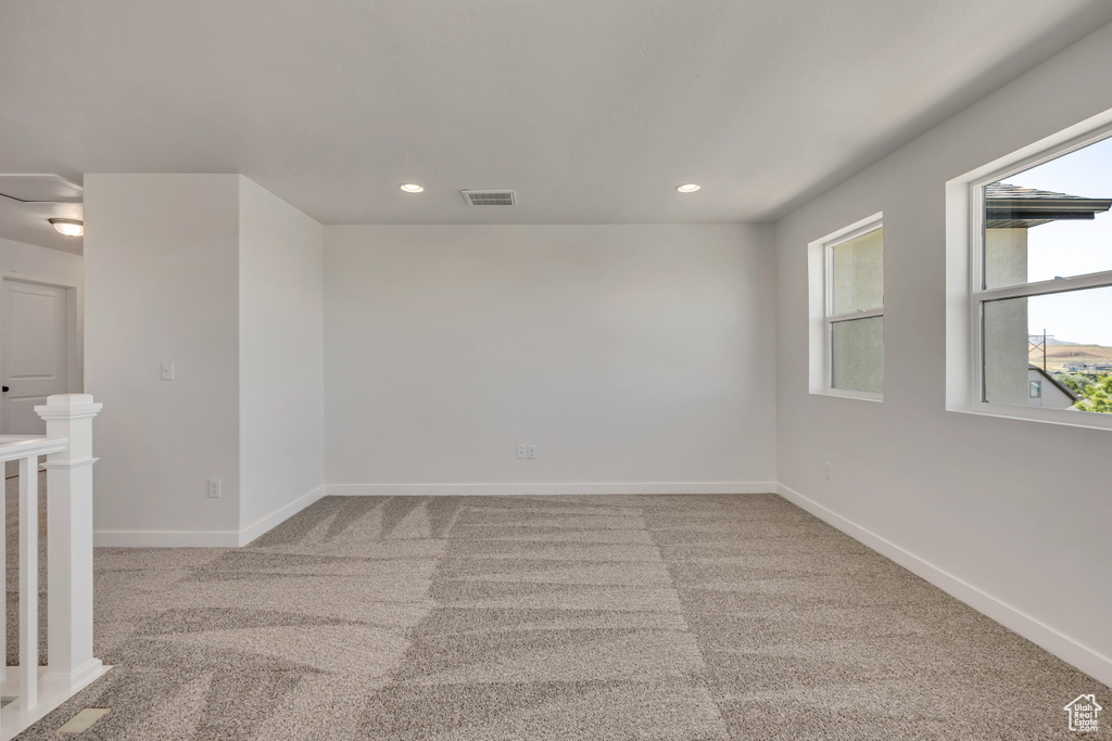 Carpeted spare room featuring recessed lighting