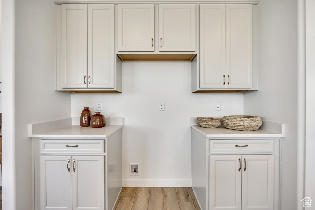 Kitchen with light countertops and light wood-style floors