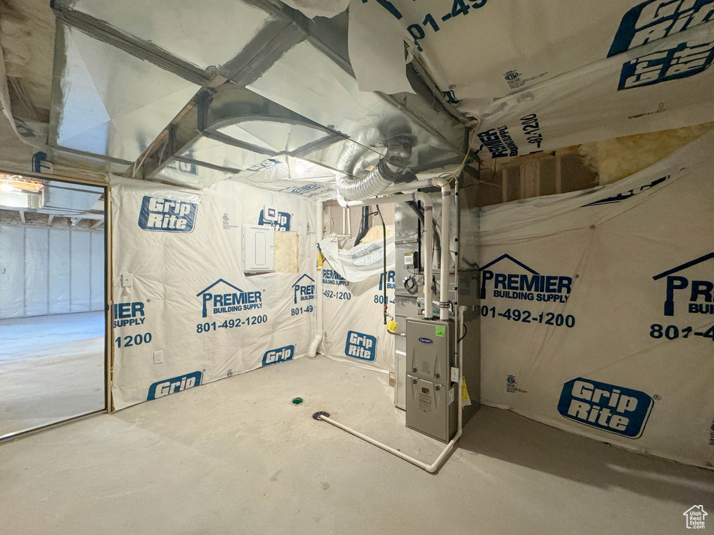 Unfinished below grade area featuring heating unit