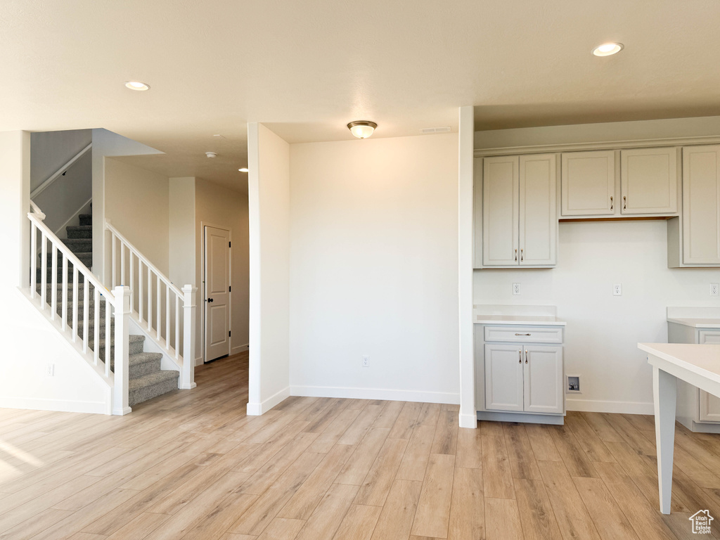 Kitchen featuring light wood-type flooring, recessed lighting, gray cabinets, and light countertops