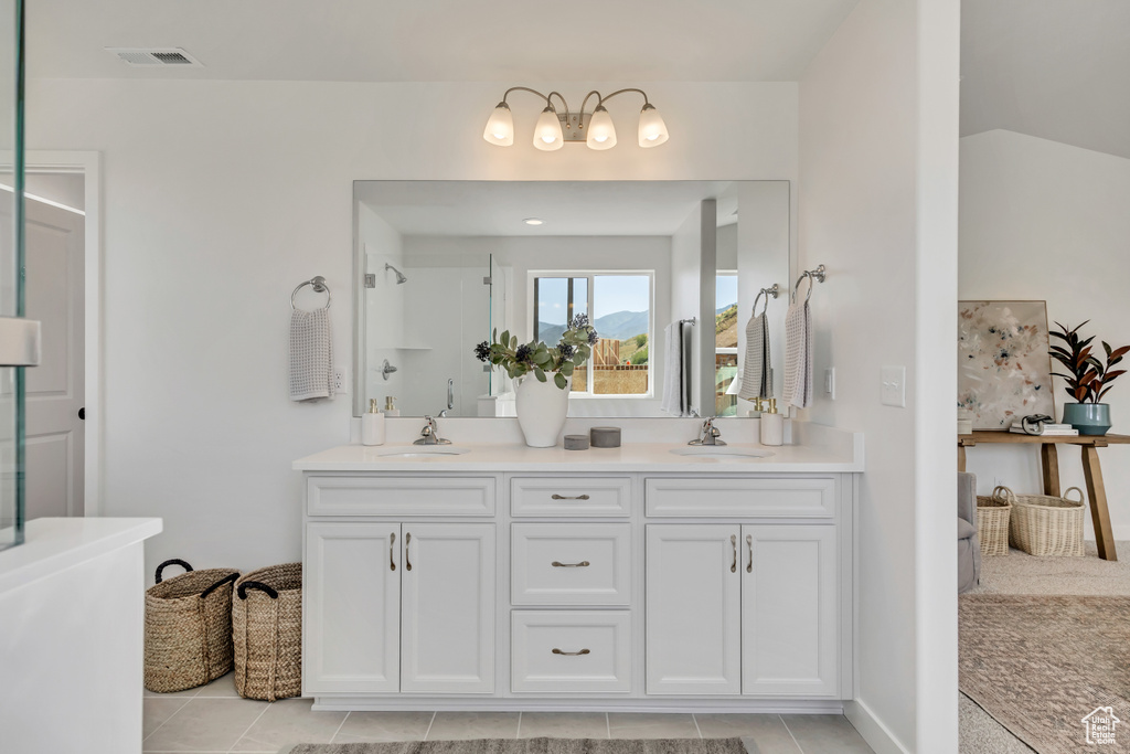 Bathroom with double vanity, tile patterned flooring, a shower, and a bathtub