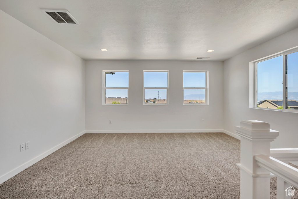 Carpeted spare room with recessed lighting