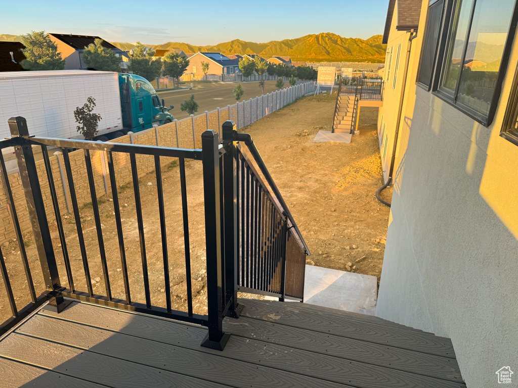 Wooden deck featuring a mountain view and a residential view