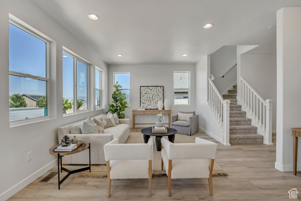 Living area featuring stairs, recessed lighting, and light wood-type flooring
