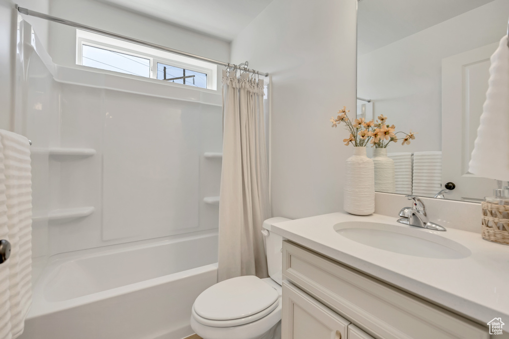Full bathroom with vanity and shower / bath combo with shower curtain