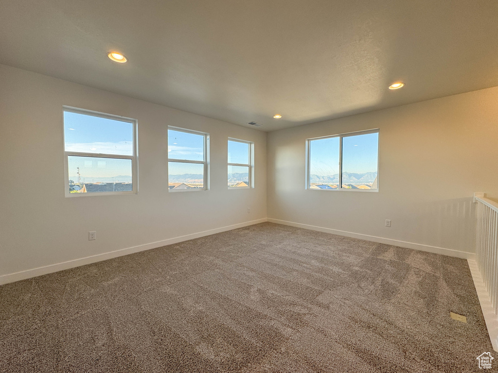 Carpeted spare room featuring recessed lighting