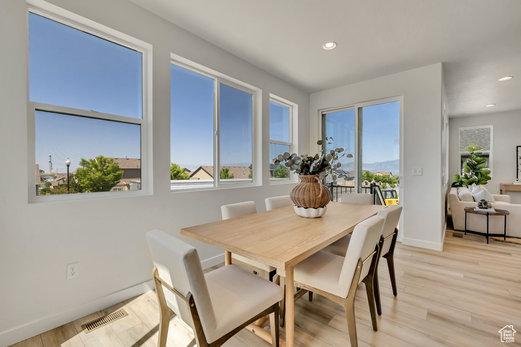 Dining room with recessed lighting and light wood-style flooring