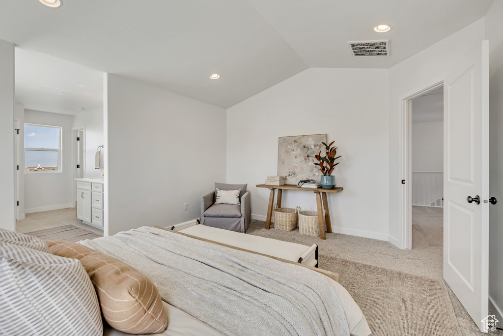 Bedroom with lofted ceiling, recessed lighting, and ensuite bath