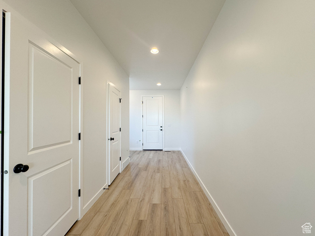 Hallway featuring light wood-type flooring and recessed lighting