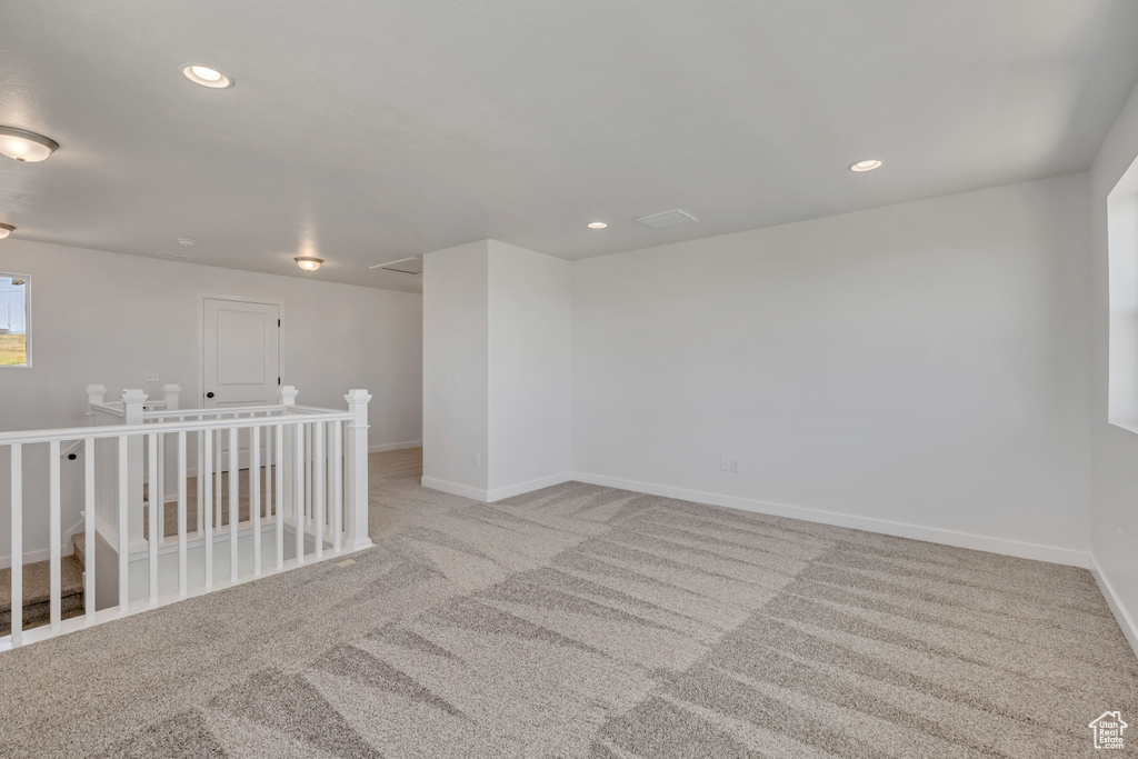Carpeted spare room featuring recessed lighting