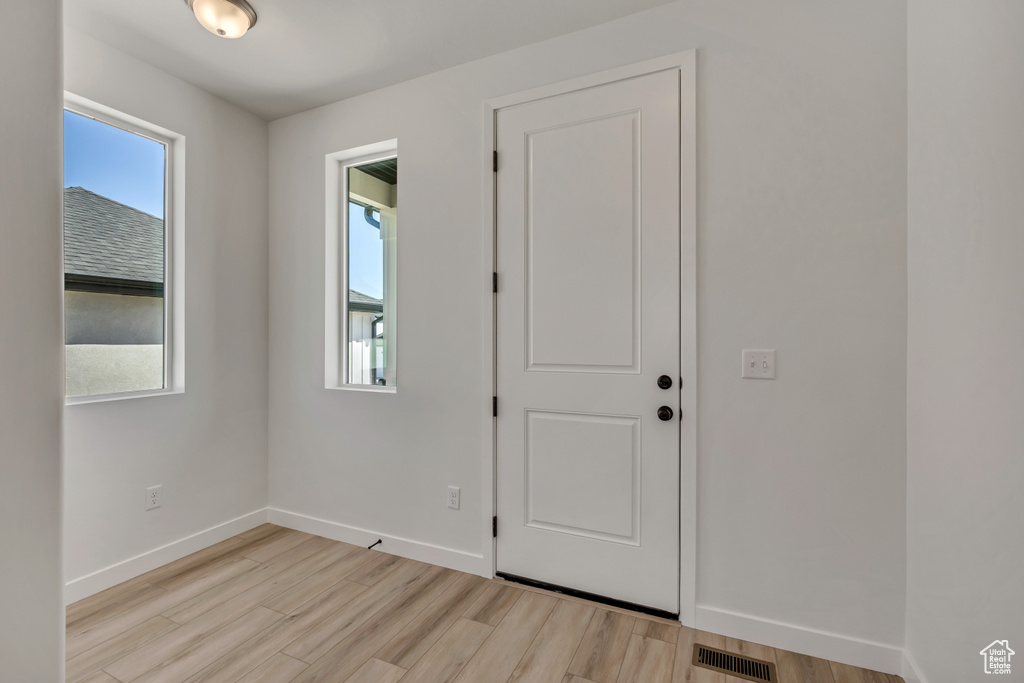 Entryway featuring light wood-type flooring and baseboards