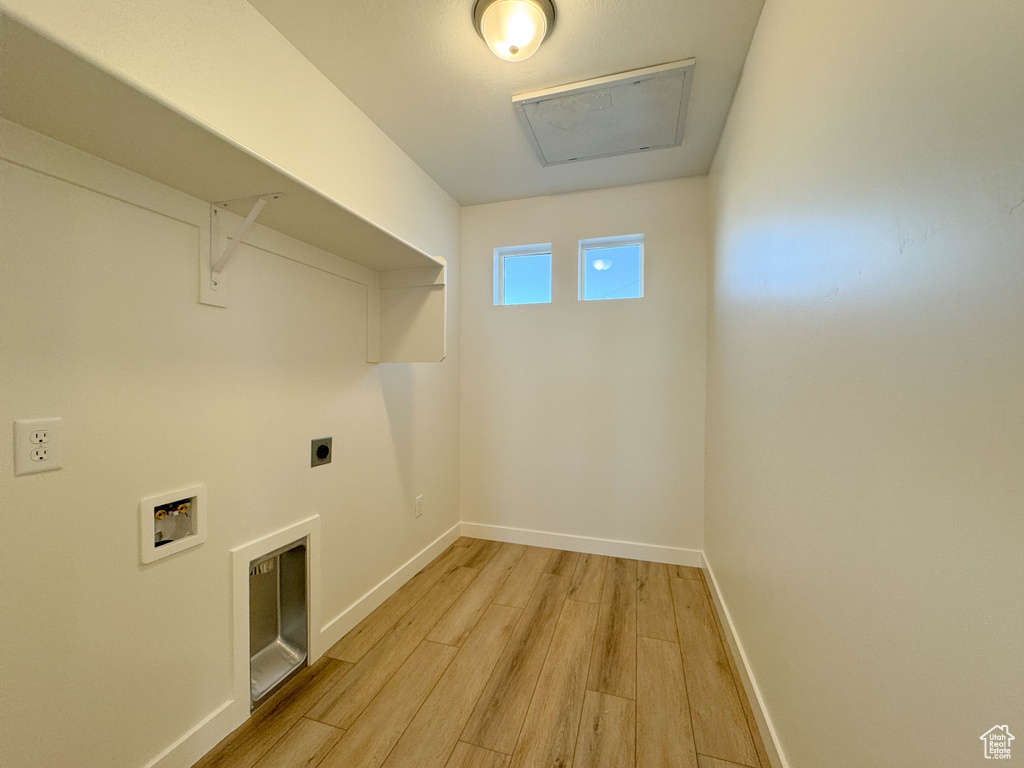 Laundry room with light wood-style floors, hookup for a washing machine, hookup for an electric dryer, and attic access