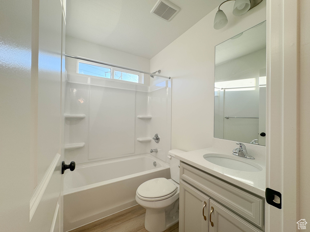 Full bath featuring vanity, shower / washtub combination, and wood finished floors