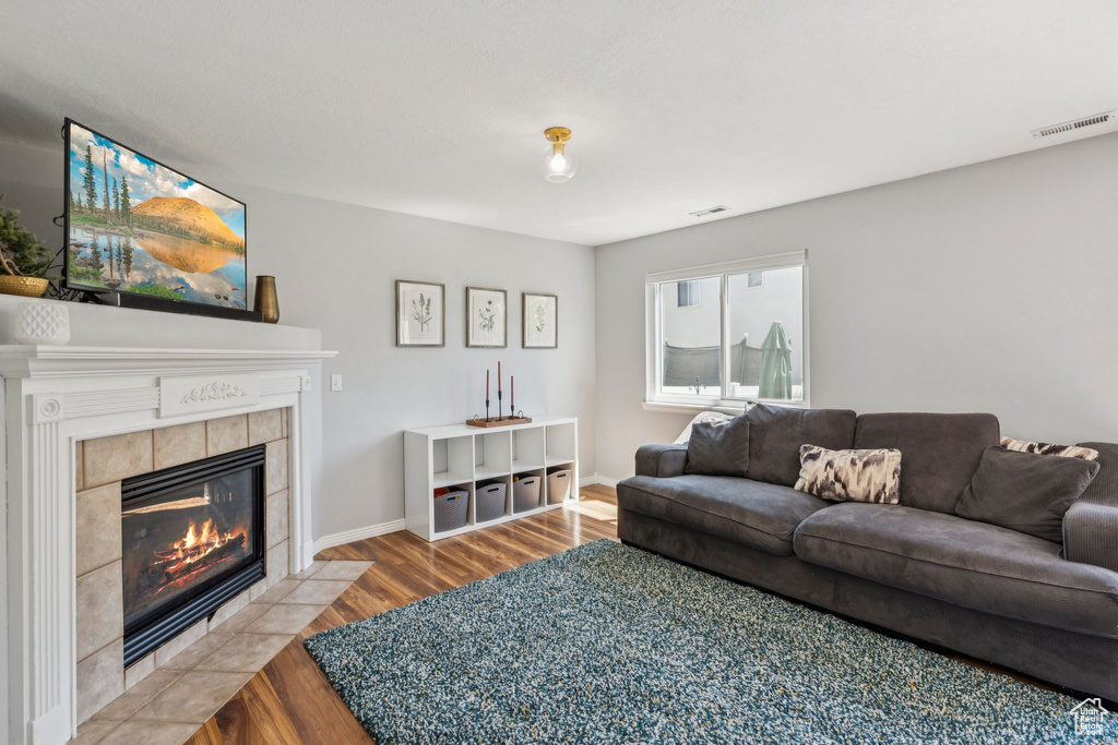 Living area featuring wood finished floors and a fireplace