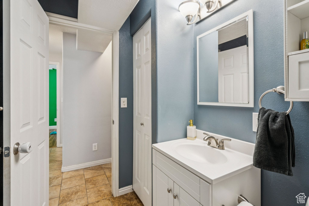 Bathroom with vanity and baseboards