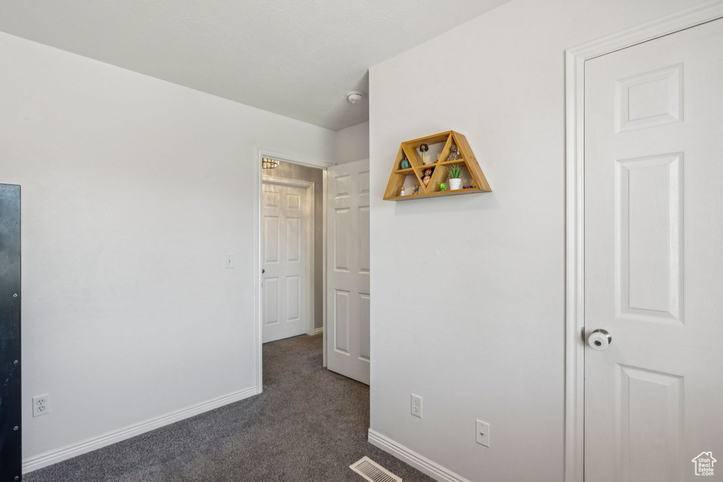 Unfurnished bedroom with carpet floors and baseboards