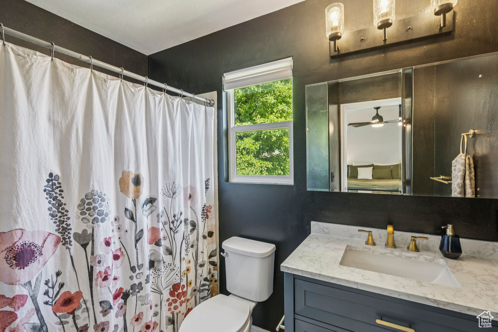 Full bathroom with vanity and curtained shower