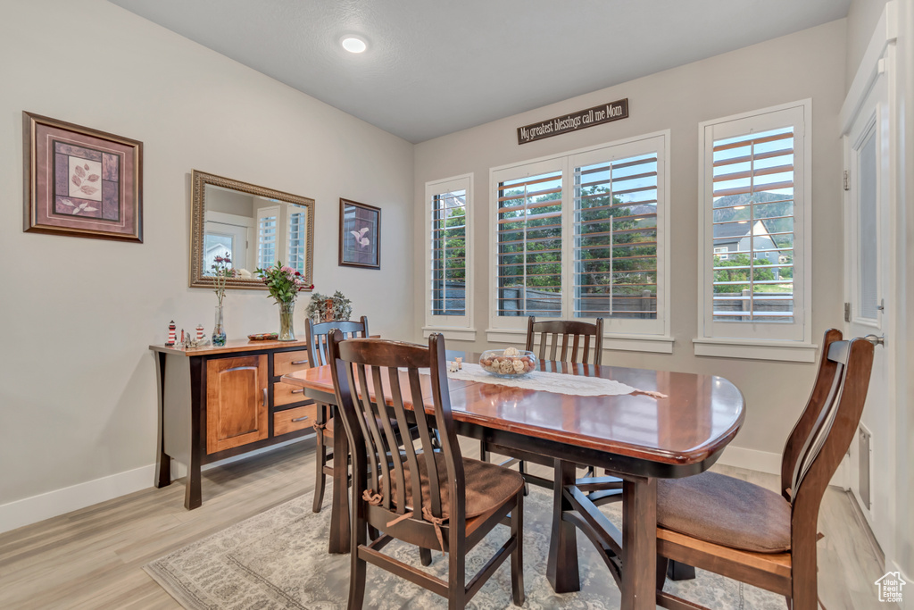 Dining space featuring baseboards, light wood-style floors, and recessed lighting