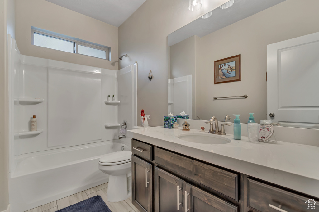Full bathroom with vanity, tub / shower combination, and toilet