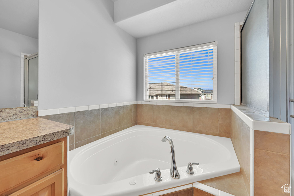Bathroom featuring vanity and a jetted tub
