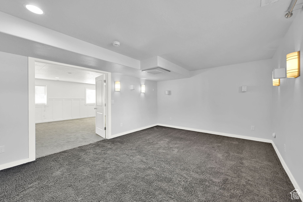 Basement with dark carpet