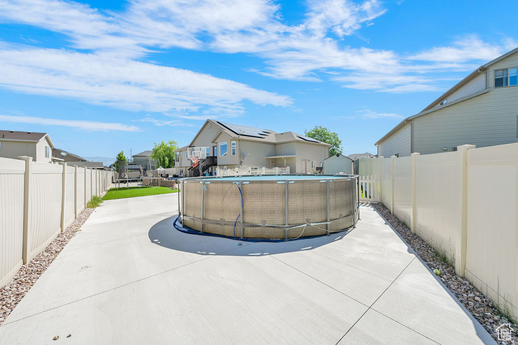 View of pool featuring a residential view and a fenced backyard