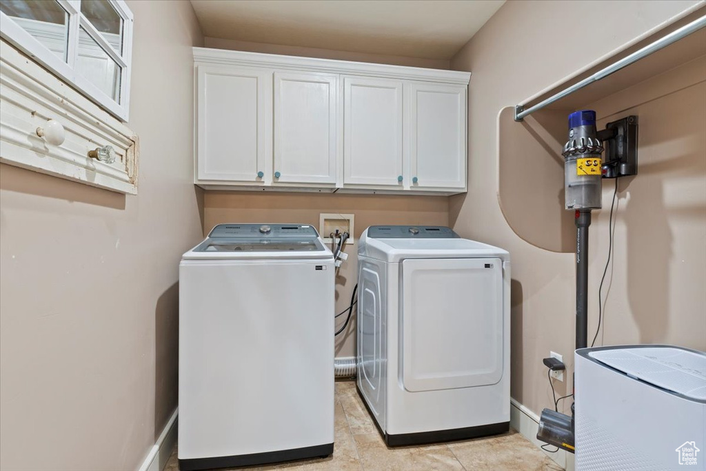 Laundry area featuring washer and dryer and cabinet space