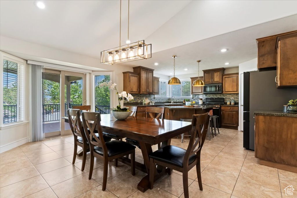 Dining room featuring recessed lighting, light tile patterned floors, and vaulted ceiling