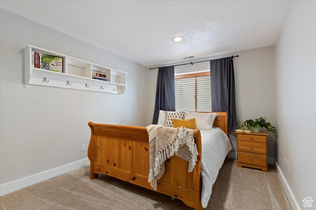 Carpeted bedroom featuring baseboards