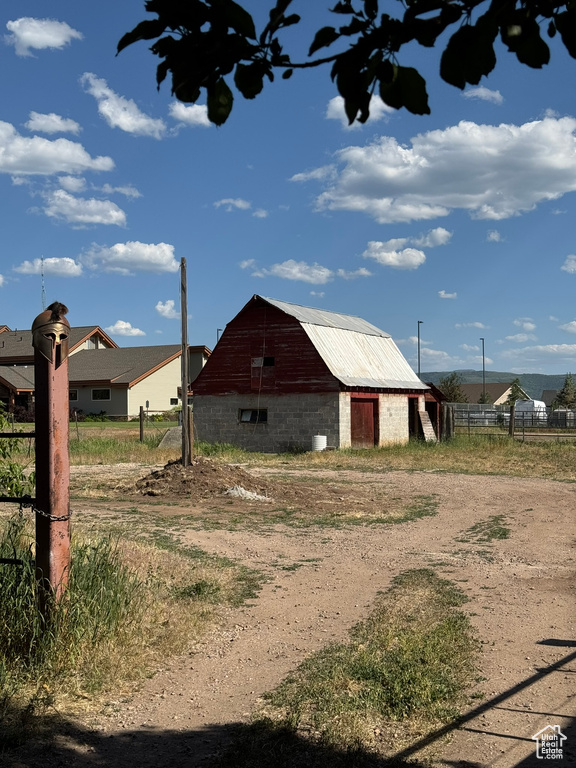 View of side of home featuring a barn, an outbuilding, and a garage