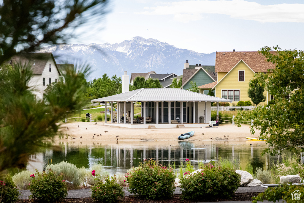 Rear view of house with a chimney, a water and mountain view, and a metal roof