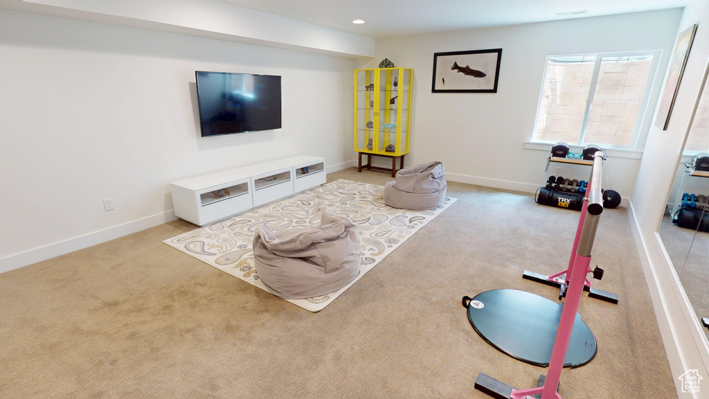 Carpeted living room featuring baseboards and recessed lighting