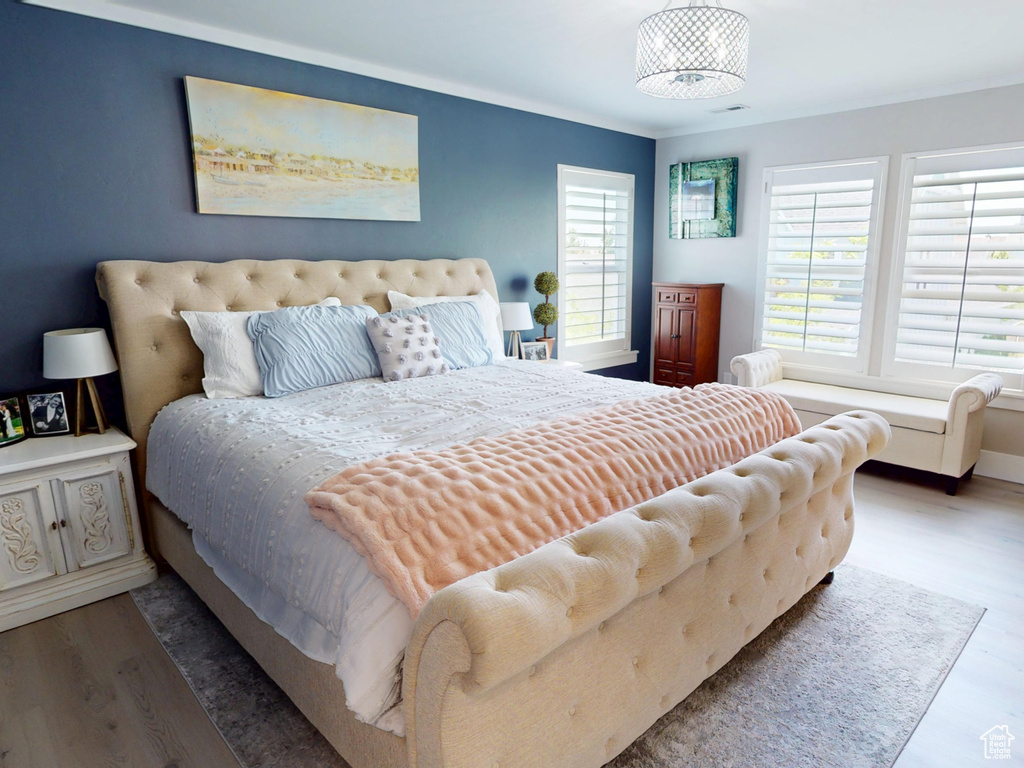 Bedroom featuring wood finished floors and baseboards
