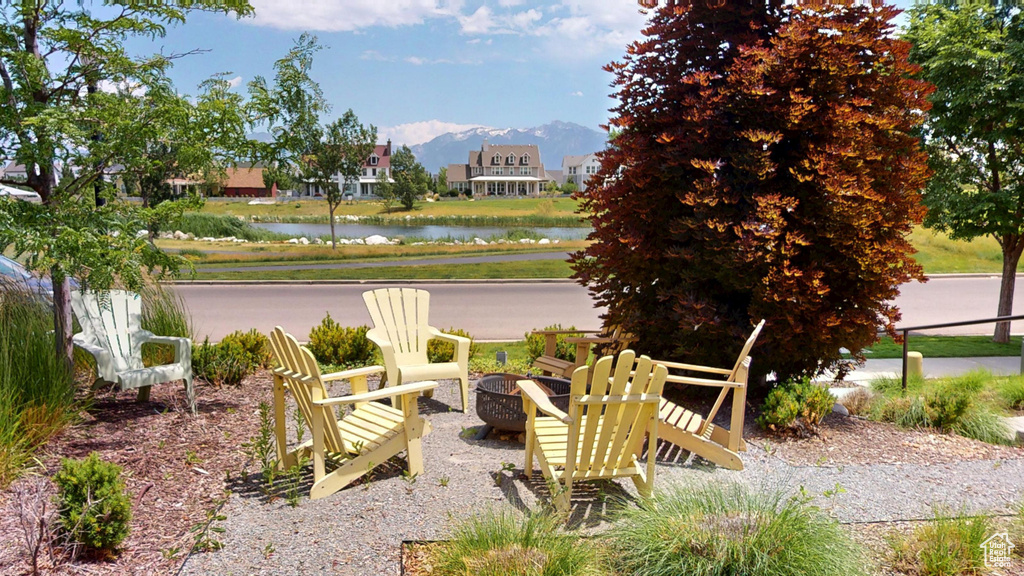 View of patio with a water and mountain view and a fire pit