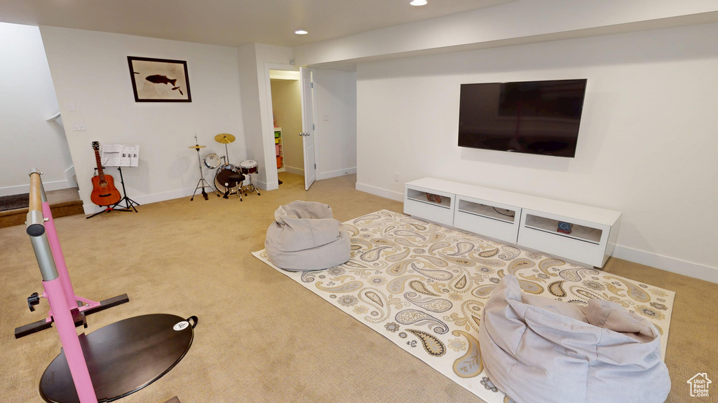 Carpeted living room featuring recessed lighting and baseboards