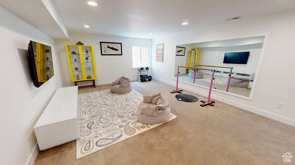 Carpeted living room featuring recessed lighting and baseboards