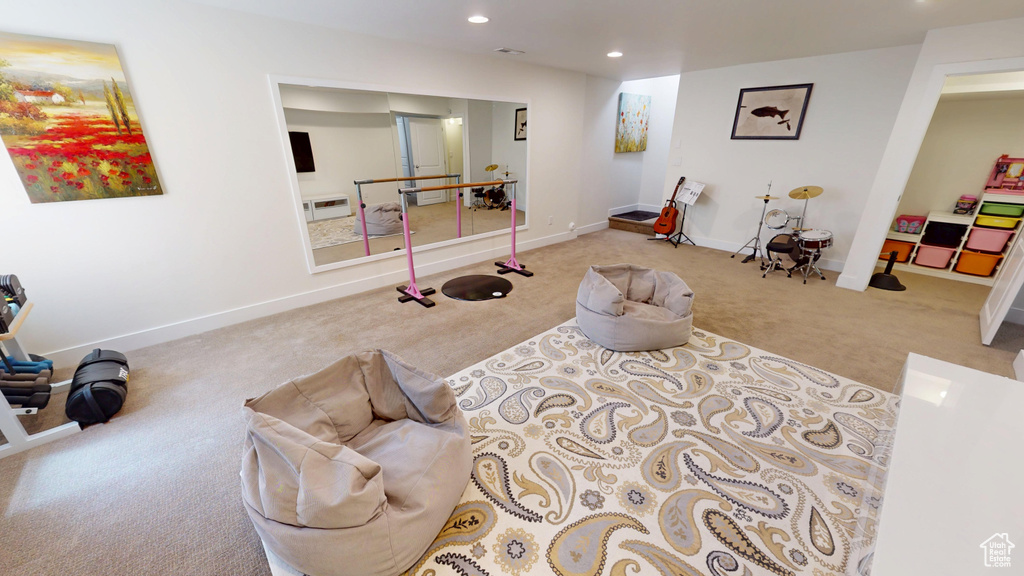 Carpeted living room with recessed lighting and baseboards