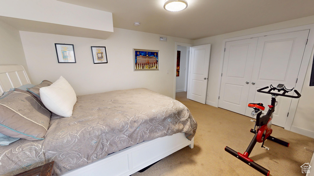 Carpeted bedroom featuring a closet