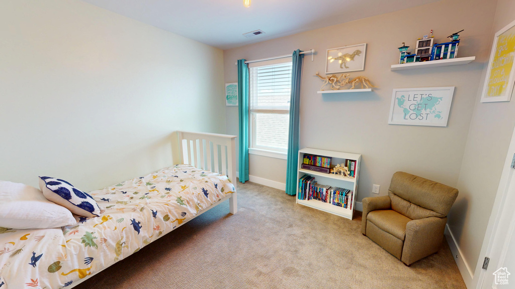 Bedroom featuring carpet flooring and baseboards