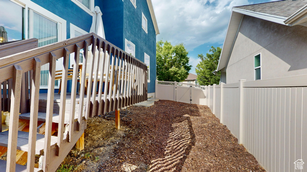 View of home\\\'s exterior with a gate and stucco siding