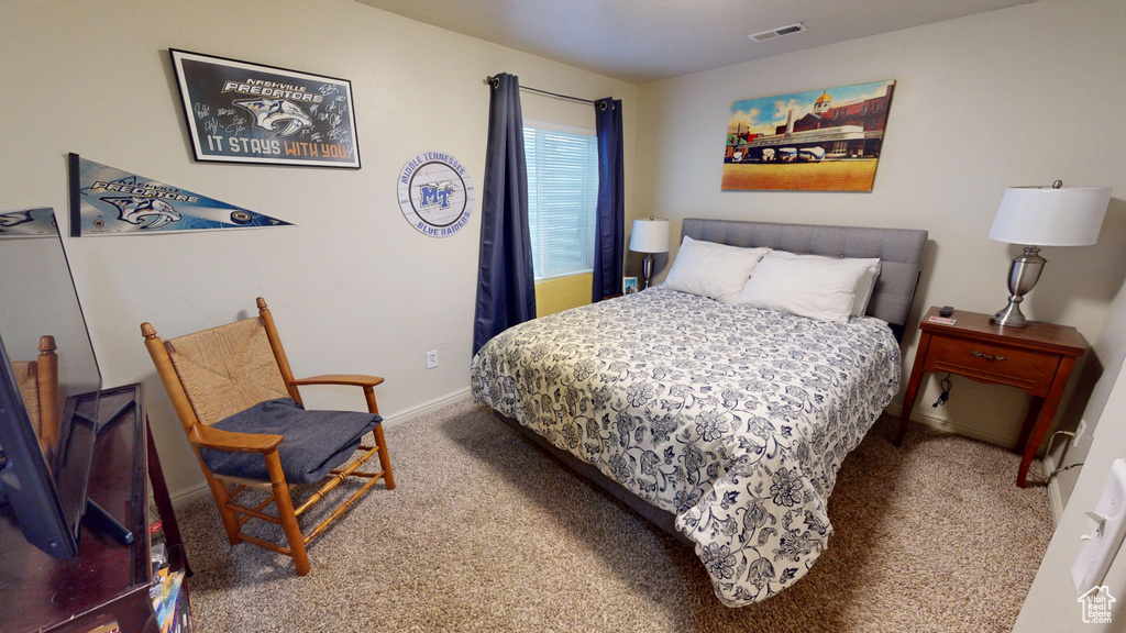 Carpeted bedroom featuring baseboards