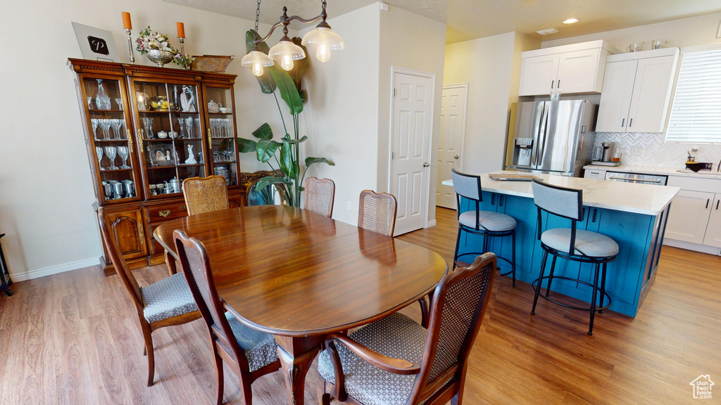 Dining space with light wood-type flooring and recessed lighting