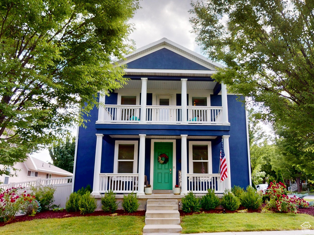 View of front of house with a balcony and a porch
