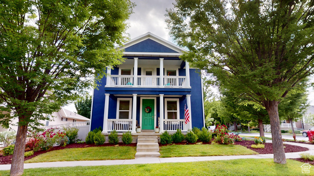 View of front of house with a balcony and a porch